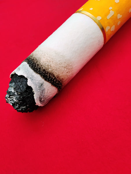 Cigarette butt on a red background