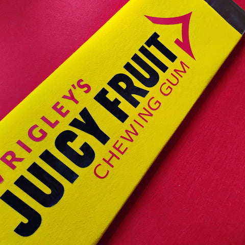 Wrigley's Juicy Fruit chewing gum pack on a red background