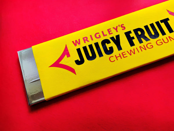 Wrigley's Juicy Fruit chewing gum pack on a red background