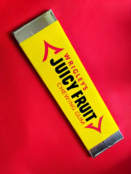 Wrigley's Juicy Fruit chewing gum pack on a red background