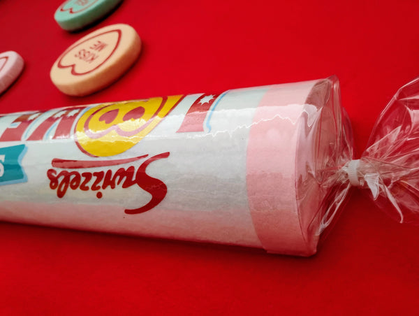 Candy Love Hearts
 in a clear wrapper on a red background