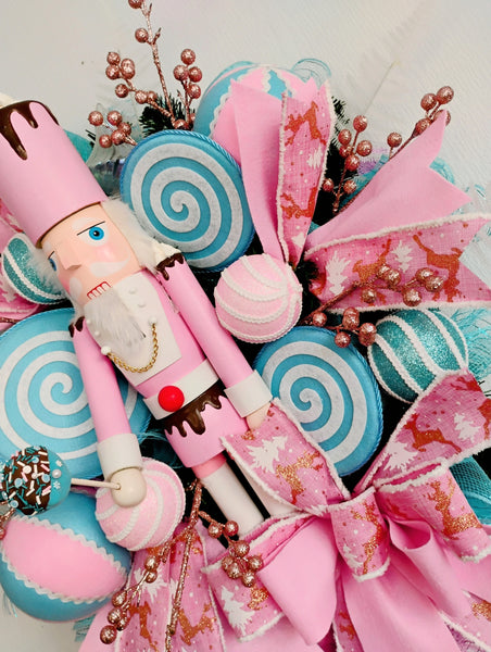 Decorative bouquet with a nutcracker figure, pink ribbons, and candy-themed elements on a white background.