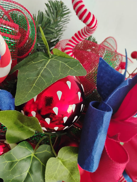 Close up of a strawberry bauble on a  Strawberry Fruit Burst Wreath with lots of handmade picks and sprays
