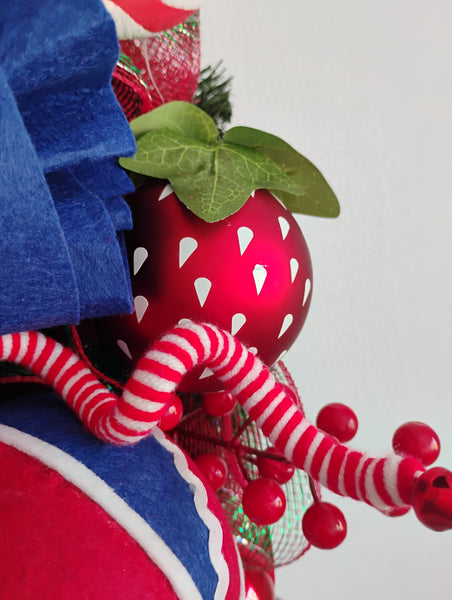 Close up of a strawberry bauble on a  Strawberry Fruit Burst Wreath with lots of handmade picks and sprays