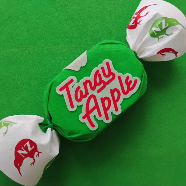 Tangy Apple candy with green and white packaging on a green background