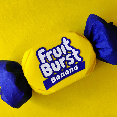 Fruit Burst Banana toy on a yellow background