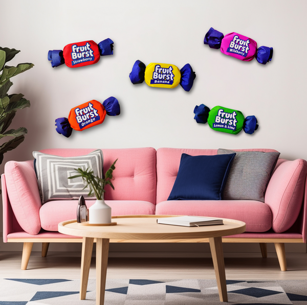 Pink sofa with colorful candy Fruit Burst decorations on a wall