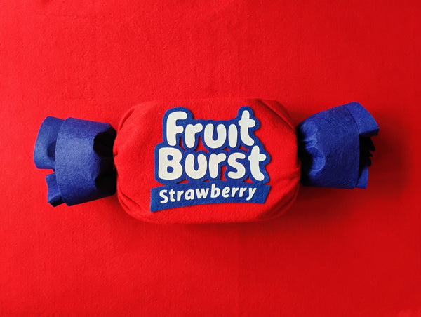 Red and blue Fruit Burst Strawberry candy on a red background