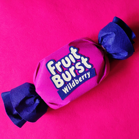 Pink and blue Fruit Burst Wildberry candy on a pink background